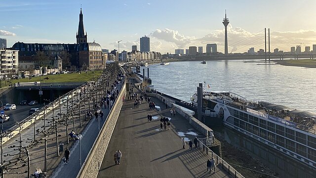 Menschen spazieren über die Rheinpromenade